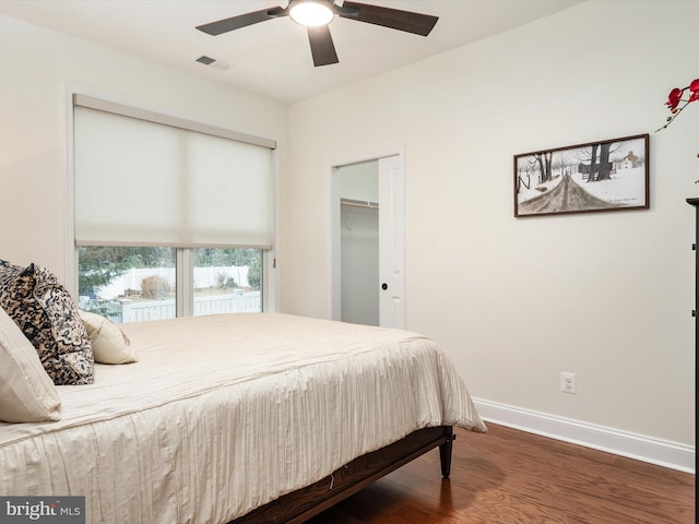 bedroom with ceiling fan, dark hardwood / wood-style flooring, and a closet