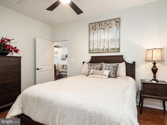 bedroom with dark hardwood / wood-style floors and ceiling fan