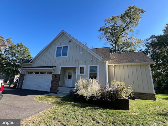 view of front of property featuring a garage and a front lawn