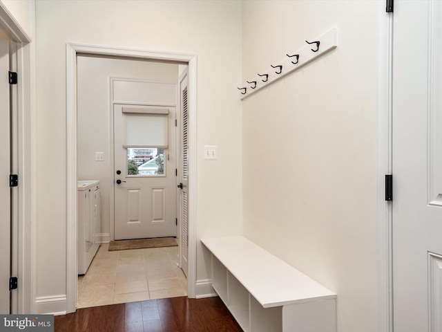 mudroom with separate washer and dryer and hardwood / wood-style floors