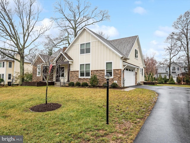 view of front of house featuring a garage and a front lawn