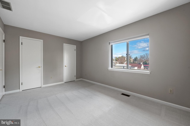 unfurnished bedroom featuring light colored carpet