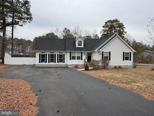 cape cod house featuring crawl space, driveway, and fence