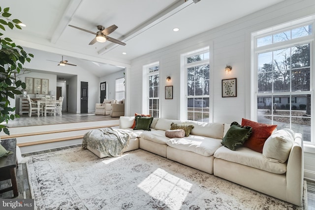 sunroom with a healthy amount of sunlight and lofted ceiling with beams