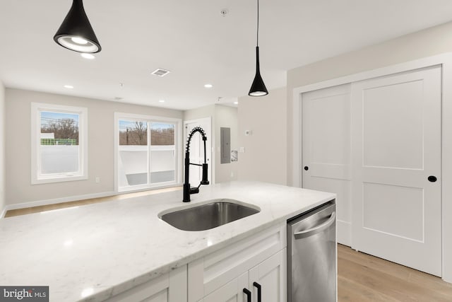 kitchen featuring sink, dishwasher, light stone counters, white cabinets, and decorative light fixtures