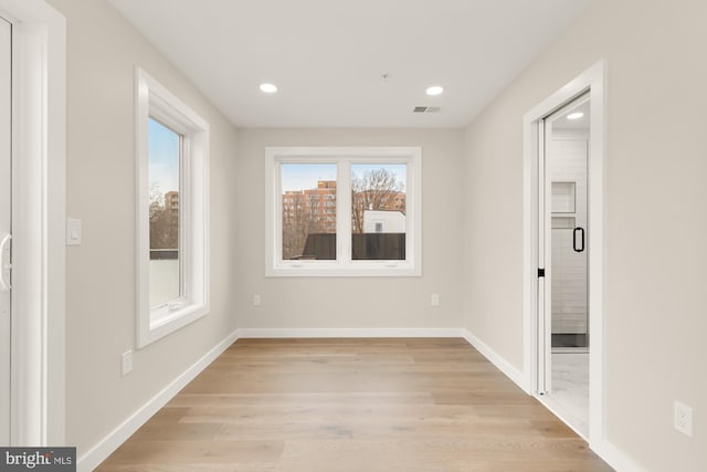 empty room with light hardwood / wood-style flooring