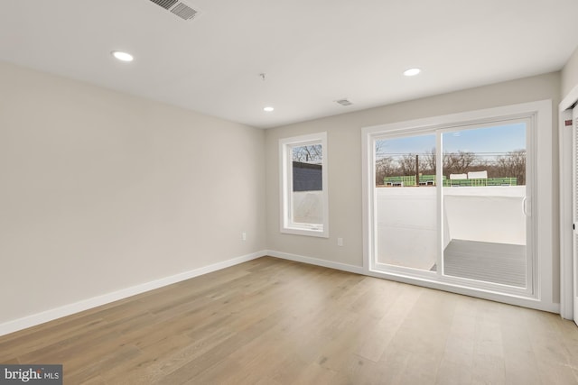 spare room with light hardwood / wood-style floors