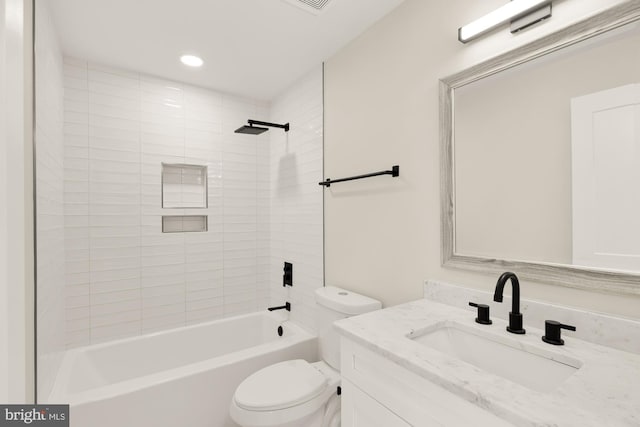 full bathroom with vanity, toilet, and tiled shower / bath combo