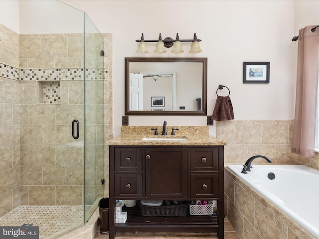 bathroom with vanity and separate shower and tub