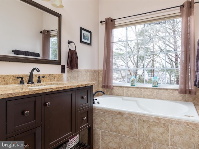 bathroom with a relaxing tiled tub and vanity