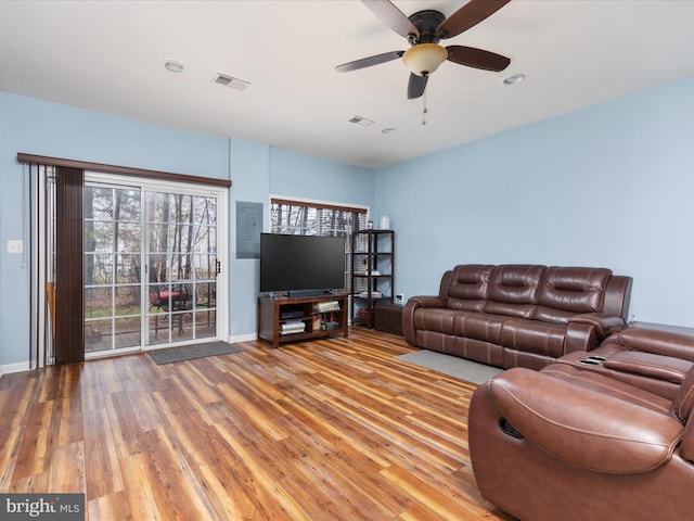 living room featuring hardwood / wood-style flooring and ceiling fan