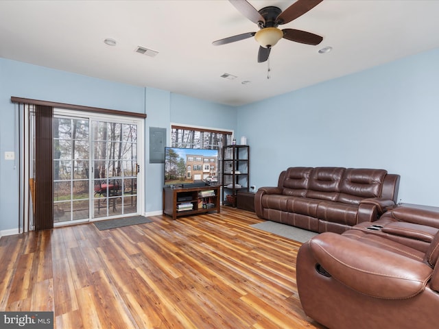 living room with a healthy amount of sunlight, hardwood / wood-style flooring, and ceiling fan