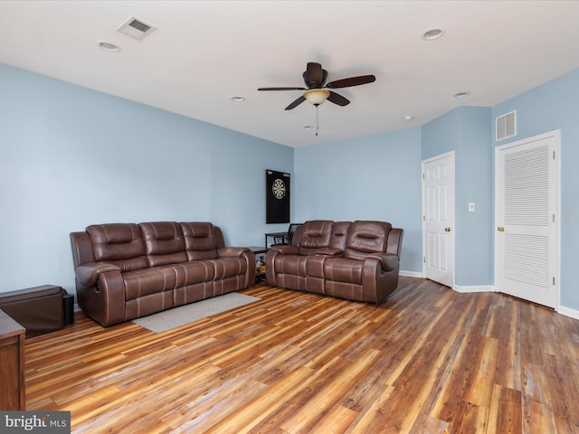 living room featuring hardwood / wood-style floors and ceiling fan