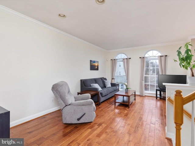 living room with hardwood / wood-style flooring and ornamental molding