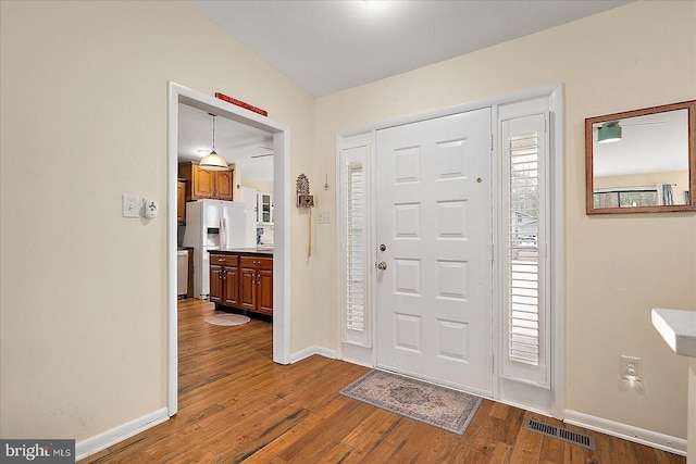 foyer with hardwood / wood-style floors and a healthy amount of sunlight