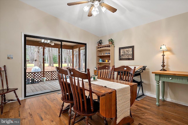 dining space featuring wood-type flooring, lofted ceiling, and ceiling fan