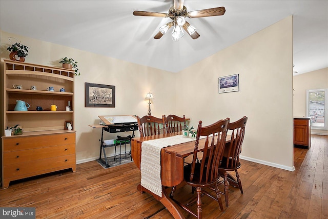 dining room with hardwood / wood-style floors and ceiling fan