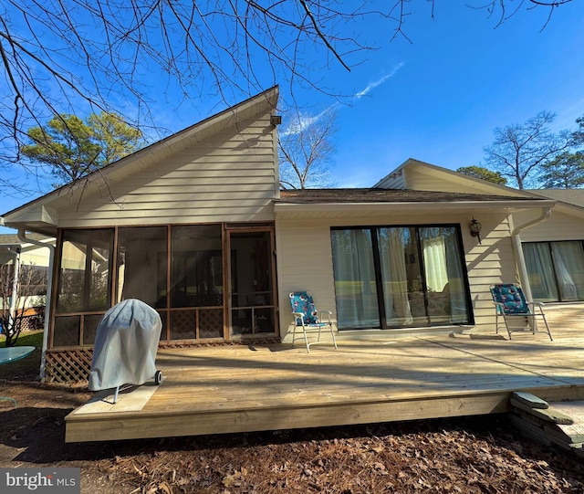 back of house with a deck and a sunroom