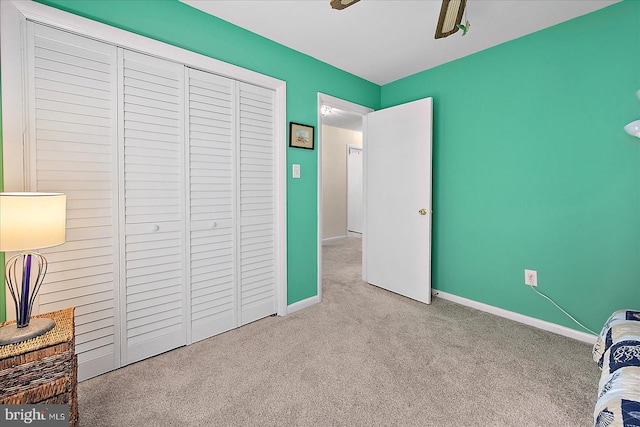 bedroom featuring a closet and light carpet