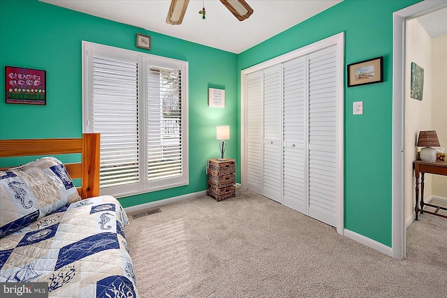 carpeted bedroom with a closet and ceiling fan