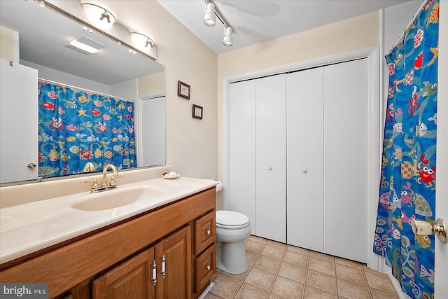 bathroom with vanity, toilet, and tile patterned flooring