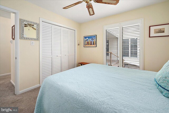 bedroom with ceiling fan, carpet floors, and a closet