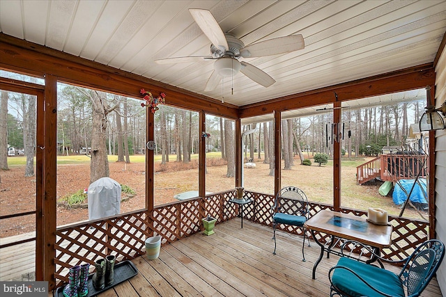 sunroom with wood ceiling and ceiling fan