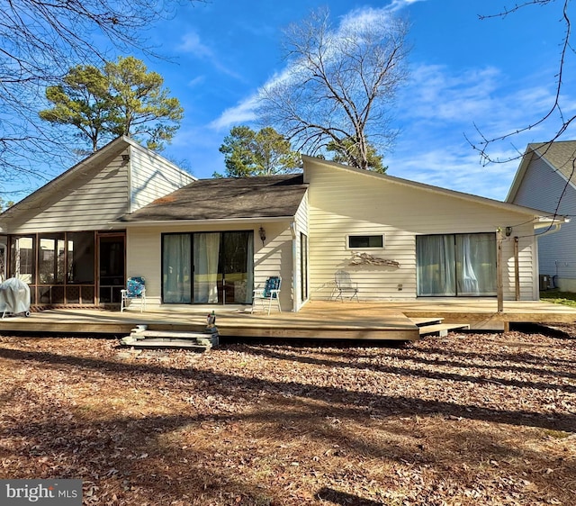 rear view of property with a deck and a sunroom