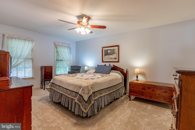 bedroom featuring light colored carpet and ceiling fan