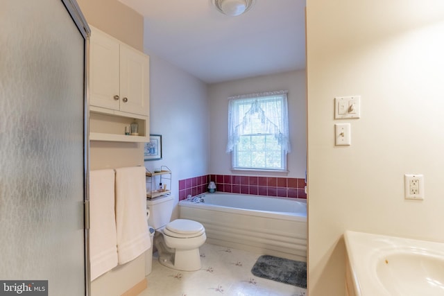 bathroom with toilet and shower with separate bathtub