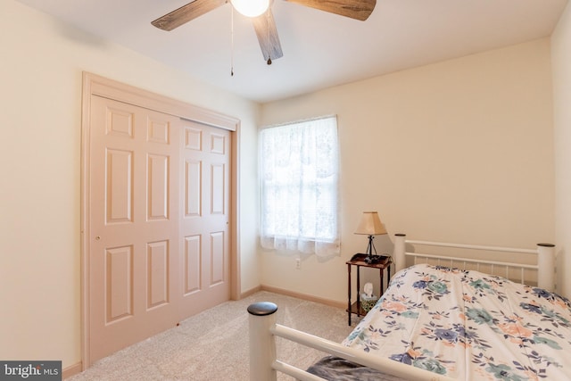 bedroom with light carpet, a closet, and ceiling fan