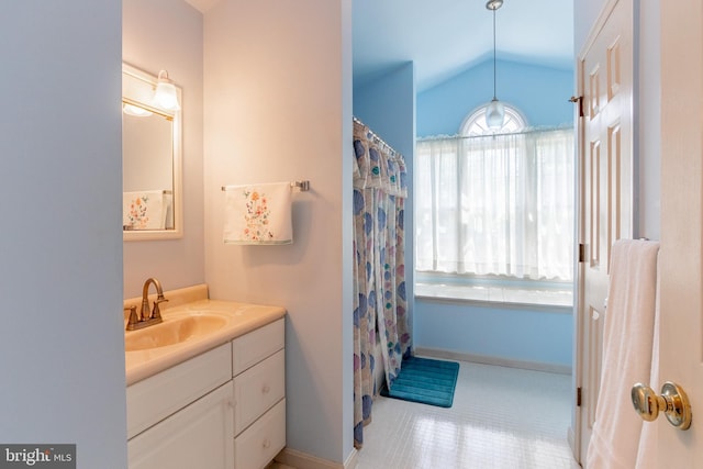 bathroom with vanity and vaulted ceiling