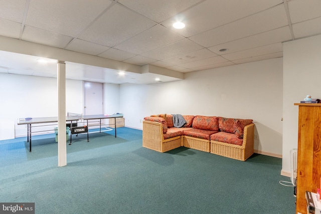 carpeted living room with a drop ceiling