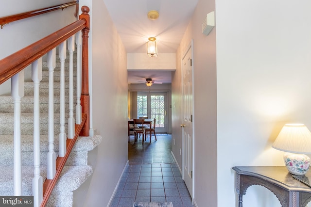 corridor featuring dark tile patterned floors