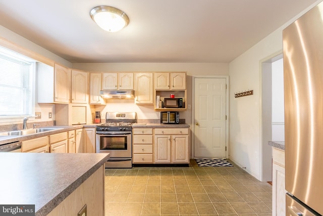 kitchen with stainless steel appliances, sink, and light brown cabinets