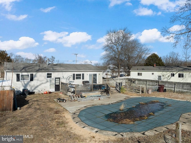 rear view of property featuring a swimming pool side deck and a patio