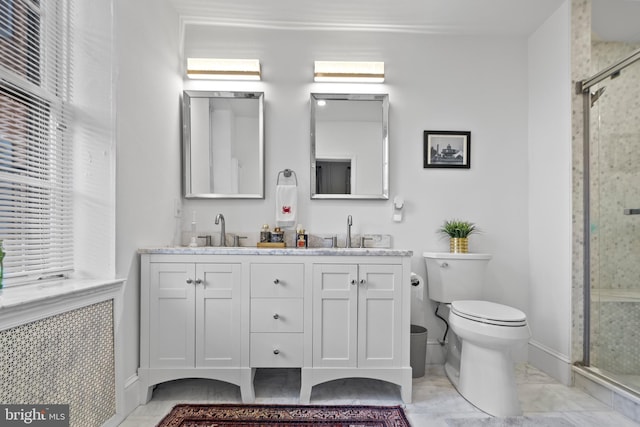 bathroom featuring an enclosed shower, vanity, and toilet