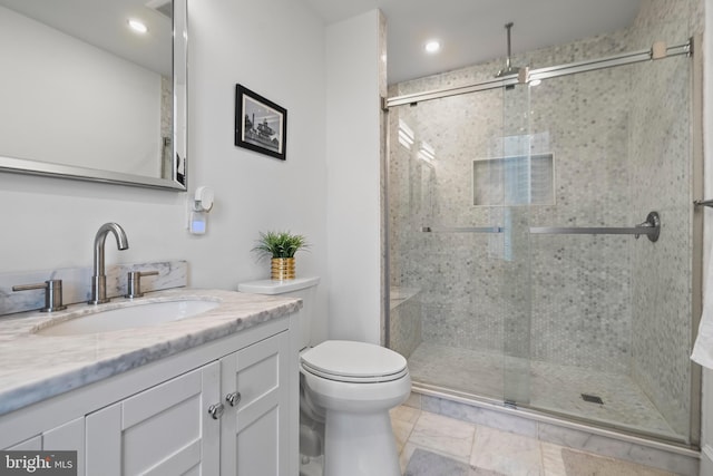 bathroom with vanity, toilet, and walk in shower