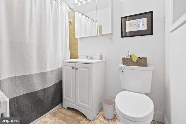 bathroom with tile patterned flooring, vanity, walk in shower, and toilet