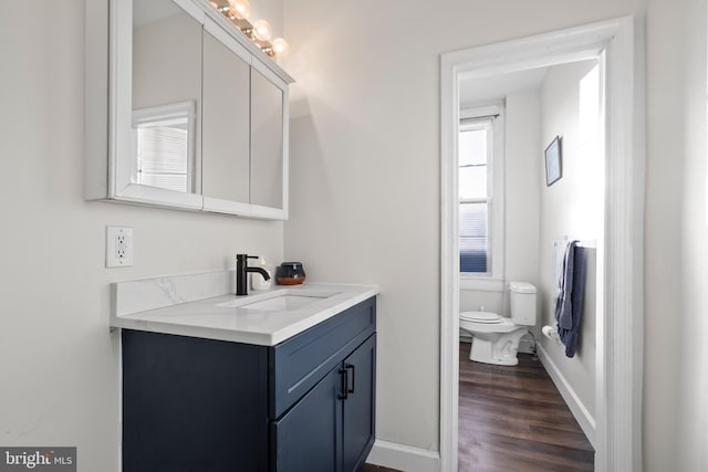 bathroom featuring vanity, toilet, and hardwood / wood-style floors