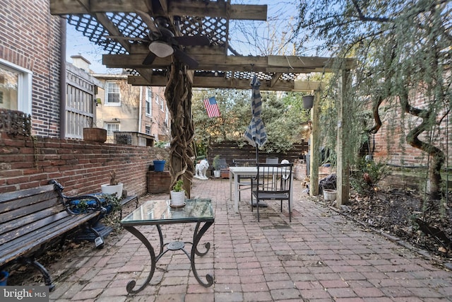 view of patio / terrace with ceiling fan and a pergola