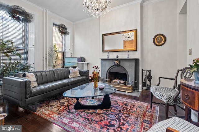 living room with hardwood / wood-style floors, ornamental molding, and a chandelier