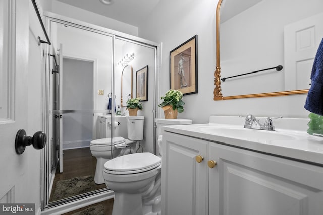 bathroom featuring vanity, hardwood / wood-style floors, and toilet