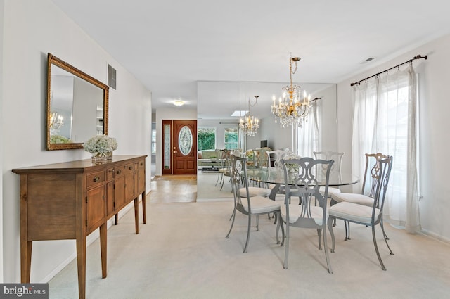 dining space with an inviting chandelier