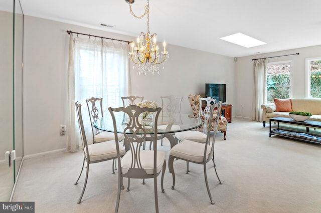 dining space featuring light carpet and a healthy amount of sunlight