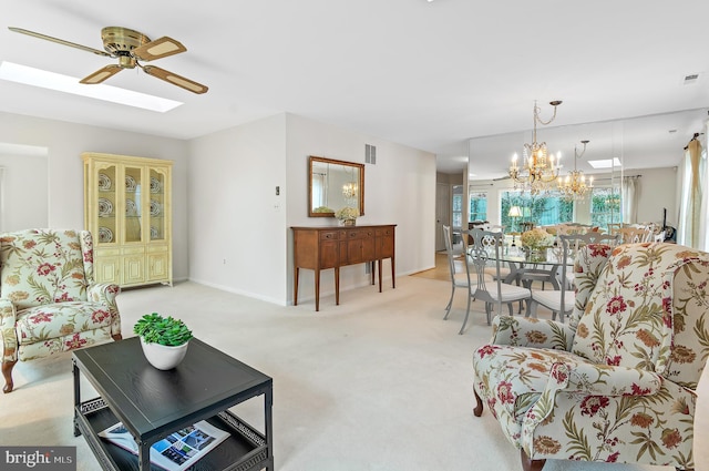 living room featuring ceiling fan with notable chandelier and light carpet