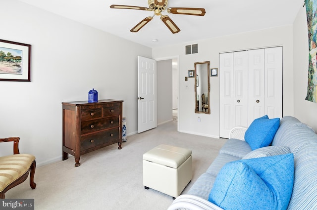 carpeted living room with ceiling fan