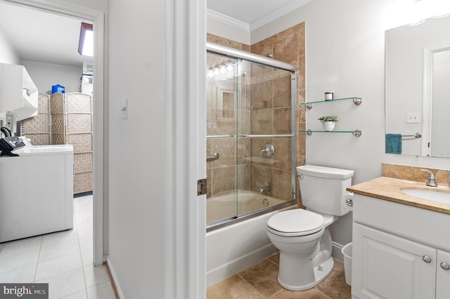 full bathroom with enclosed tub / shower combo, vanity, washer / dryer, tile patterned floors, and toilet