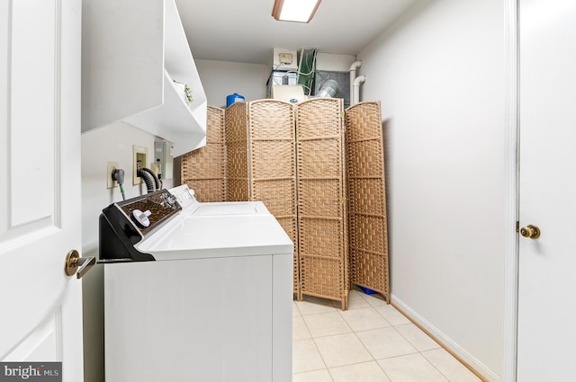 laundry area featuring washer and clothes dryer and light tile patterned flooring