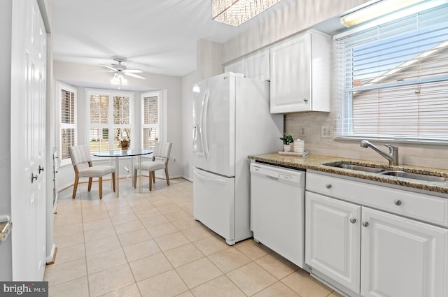 kitchen with plenty of natural light, sink, white cabinets, and white appliances